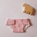 Couche poupon rayée rose et blanc